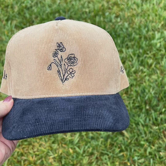 hlsembroidery signature floral detail embroidered on front of beige and navy corduroy hat 