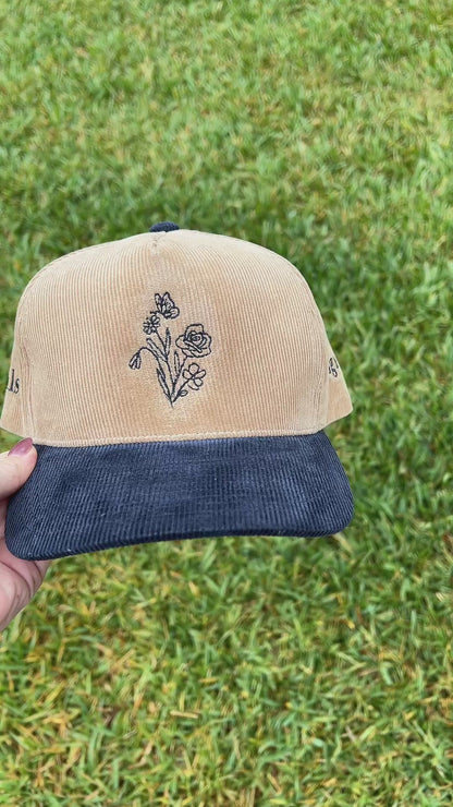 hlsembroidery signature floral detail embroidered on front of beige and navy corduroy hat 