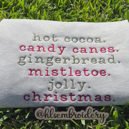 Christmas wording embroidered on gray fabric 