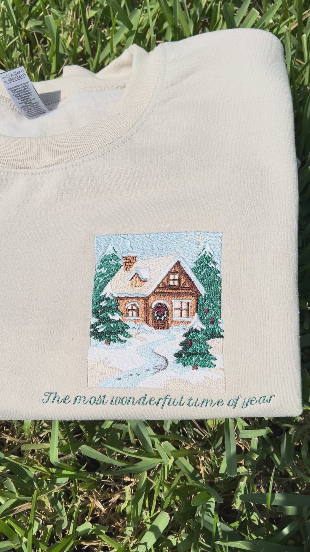 Embroidered Crewneck -with the words "The most wonderful time of year below a snowy scenic cabin